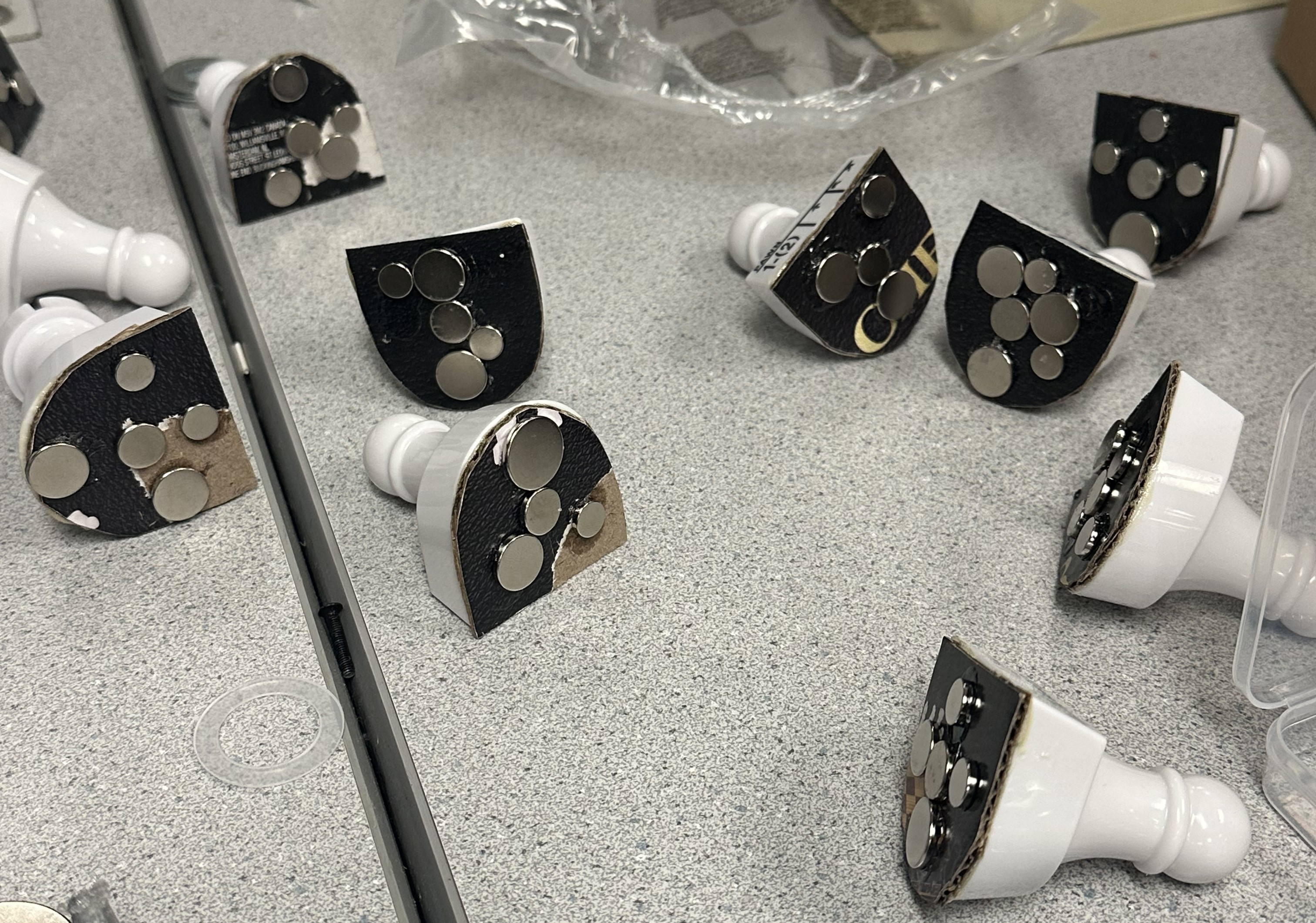Chess pieces with neodymium magnets attached to their bases