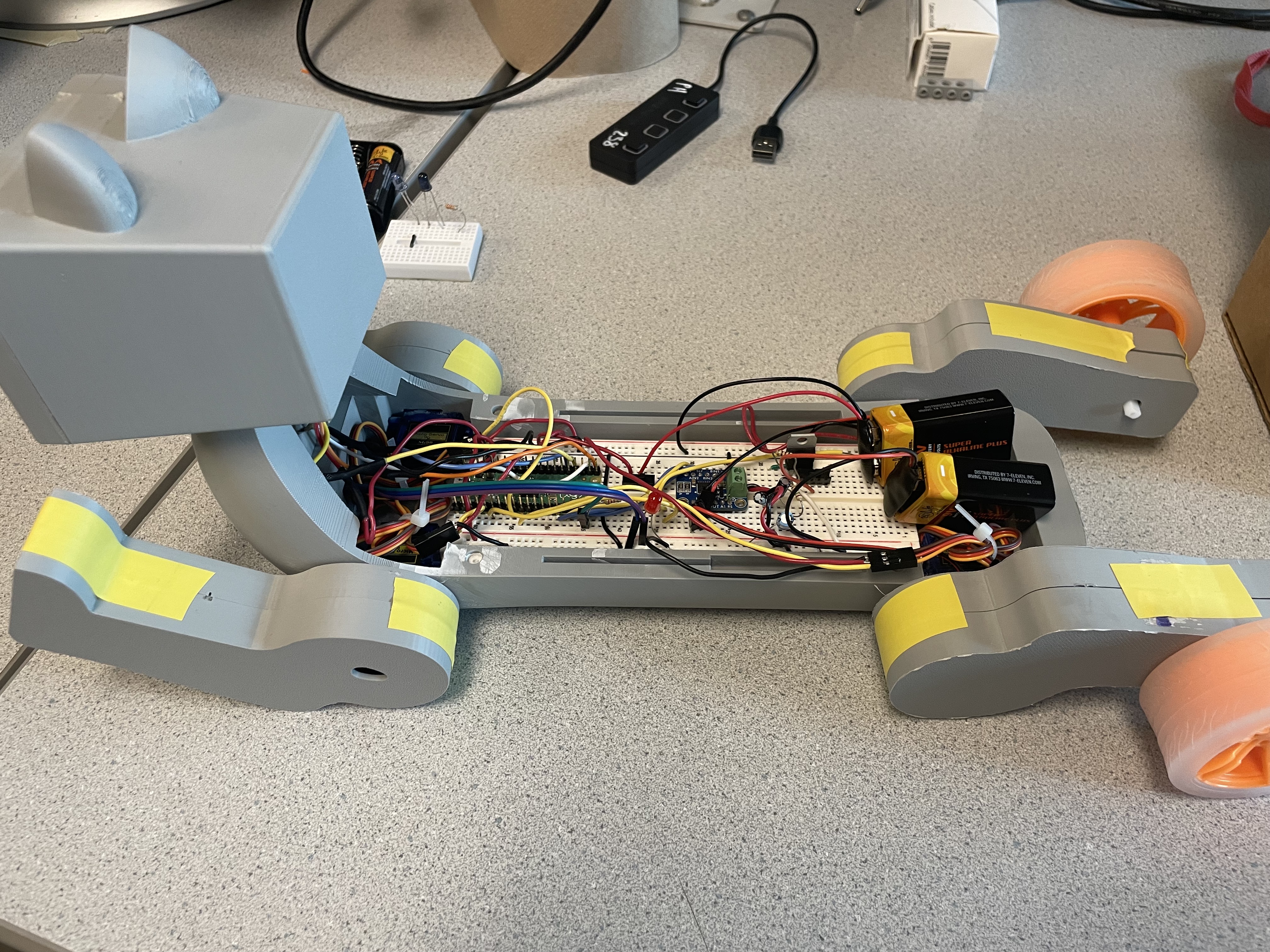 A Sideview Picture of the Cat Including the Breadboard and Batteries